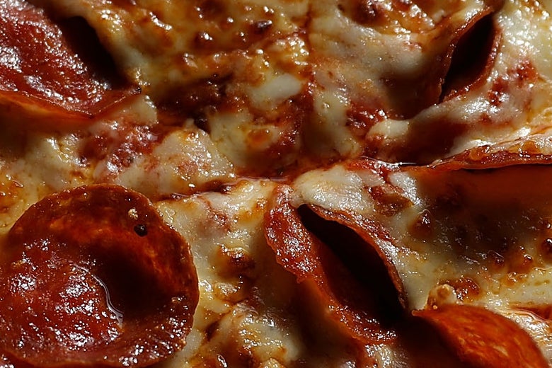 A Papa John's pizza with pepperoni seen in closeup.